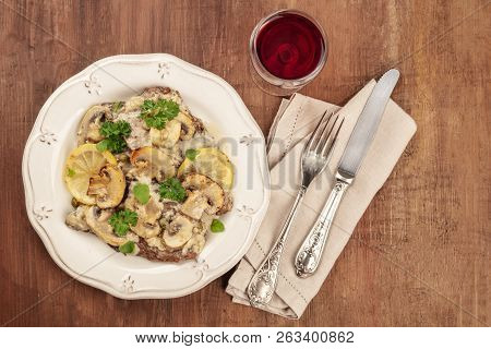A Photo Of Scallopine Di Vitello, Veal Scallopini, With A Mushroom Sauce, Lemons, And Parsley, Shot 