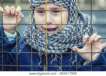 Crying Refugee Girl From The East In A Headscarf
