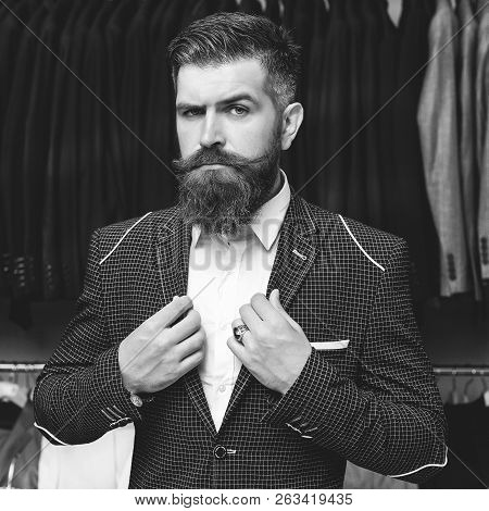 Sale, Shopping, Fashion, Style And People Concept - Elegant Young Brutal Bearded Man In Suit Choosin