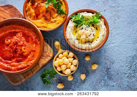  pumpkin hummus red pepper hummus and lentils hummus on wooden table