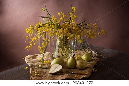 Beautiful Still Life With A Branch Of Mimosa And Pears