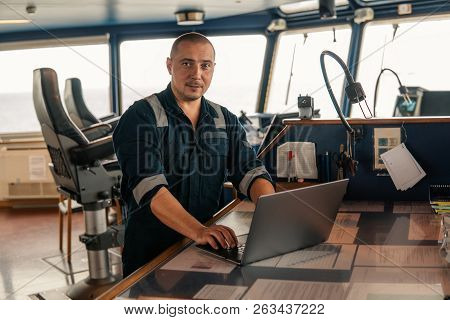 Marine Navigational Officer Is Using Laptop Or Notebook At Sea