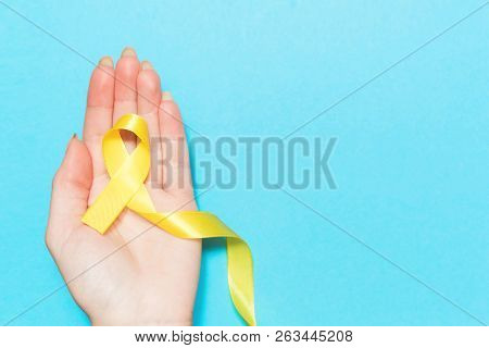 Yellow Cancer Awareness Ribbon With Trail On White Background. Concept Of Health And Medicine