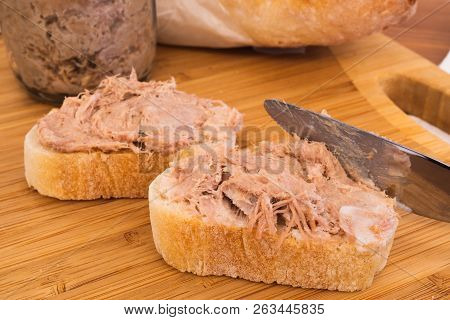 Two Homemade Rillettes French Meat Spread Made Of Pork On A Baguette Bread And Knife Spreading The R