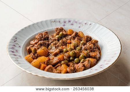 Turkish Traditional Tas Kebab With Potato, Pea And Tomato In A White Plate