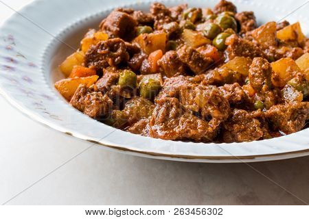 Turkish Traditional Tas Kebab With Potato, Pea And Tomato In A White Plate