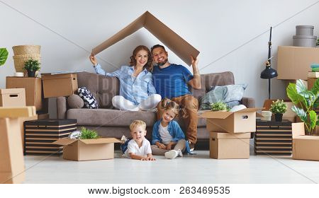 Appy Family Mother Father And Children Move To A New Apartment And Unpack Boxes