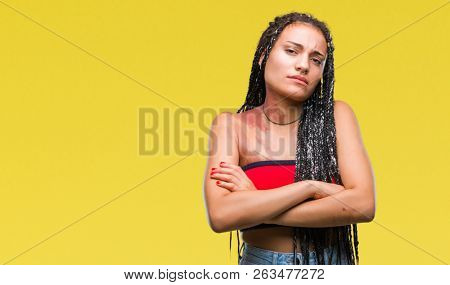 Young braided hair african american with pigmentation blemish birth mark over isolated background skeptic and nervous, disapproving expression on face with crossed arms. Negative person.