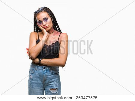 Young braided hair african american with birth mark wearing sunglasses over isolated background thinking looking tired and bored with depression problems with crossed arms.