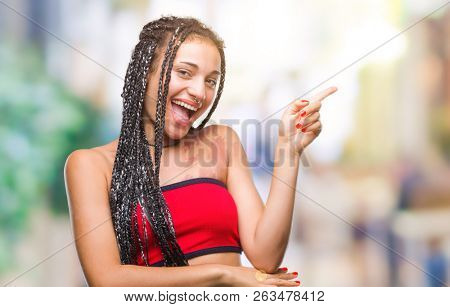 Young braided hair african american with pigmentation blemish birth mark over isolated background with a big smile on face, pointing with hand and finger to the side looking at the camera.