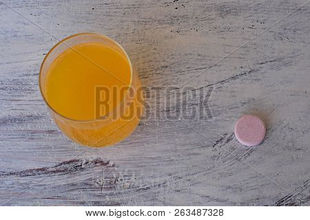 Effervescent Tablet On White Background And Orange Effervescent Bubbles Of Calcium And Vitamin C Eff