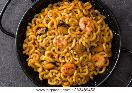 Traditional Spanish Fideua. Noodle Paella On Black Stone. Top View