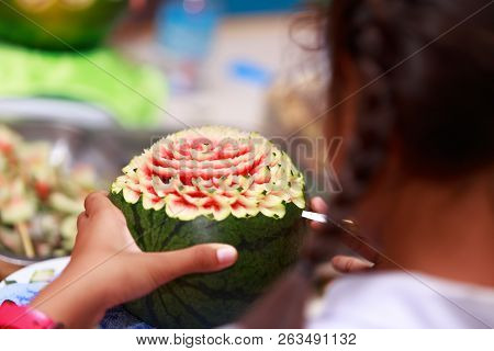 Asian Little Girl Carve Fruit In School