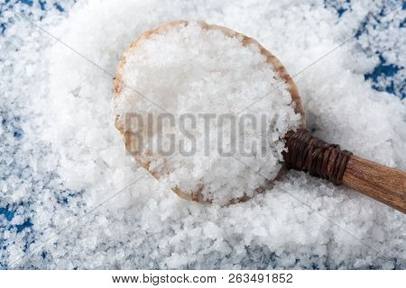Sea Salt ( Flower Of Salt / Fleur De Sel ) In A Spoon From Seashell. Top View.