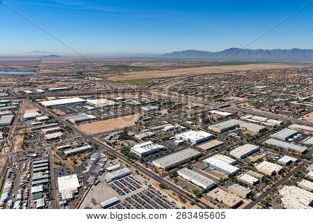 Above Industrial Buildings Near Interstate Ten Interchange In Chandler, Arizona Looking To The South