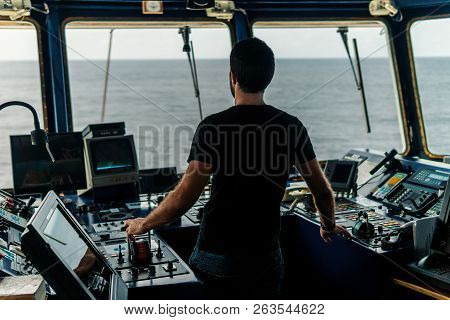 Marine Navigational Officer Is Maneuvering Ship Or Vessel