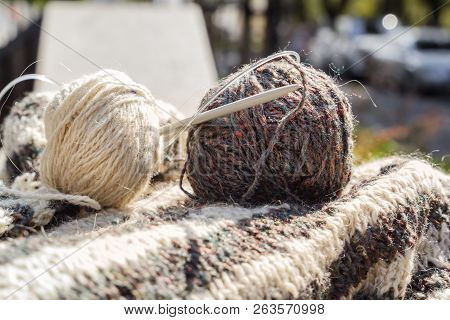 Hairs Of Wool, Knitting Needles And Woolen Clothes Are Prepared For Work. Close-up