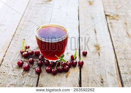Homemade Cherry Juice In Glass With Freshcherry On Wooden Table. Fresh Fruit Drink