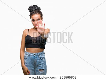 Young braided hair african american with pigmentation blemish birth mark over isolated background doing stop sing with palm of the hand. Warning expression with negative and serious gesture 