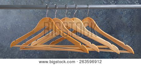 Wood Empty Hangers On Rack With Rustick Background, Copy Space
