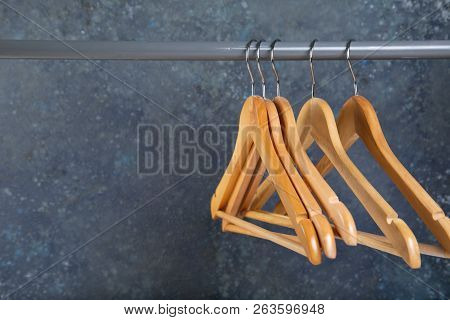 Wood Empty Hangers On Rack With Rustick Background, Copy Space
