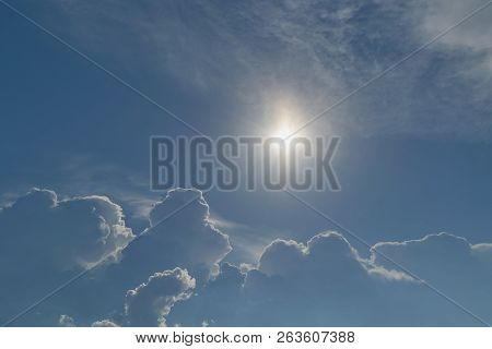 The Sun Shines Brightly In The Clear Blue Sky. Big Storm Clouds Are Coming. Cumulus Clouds Before Ra