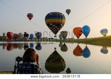 Chaingrai, Th, February 16, 2017: Woman Photographer Taking A Photo To Soar Of Balloons With Sky Bac