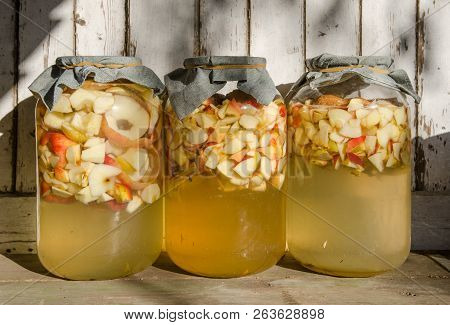 Making Of Apple Vinegar - Apple Pieces Floating On Water In A Glass