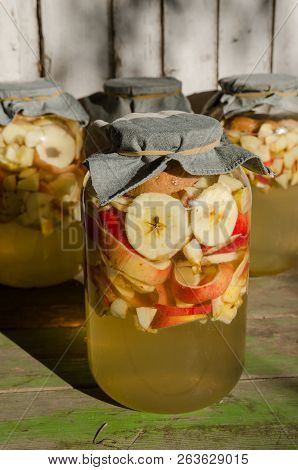 Making Of Apple Vinegar - Apple Pieces Floating On Water In A Glass