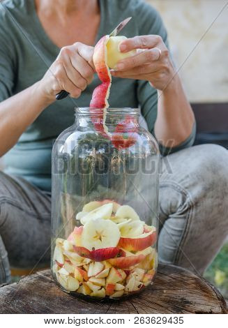 Woman Makes Apple Vinegar - Peeling Apple And Cut It Into A Bottle
