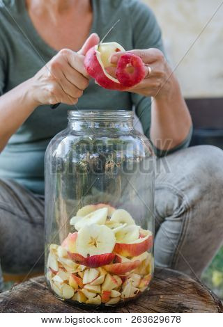 Woman Makes Apple Vinegar - Peeling Apple And Cut It Into A Bottle