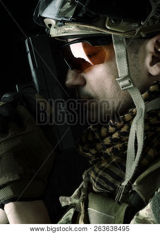 Macro View Of Military Man With Gun