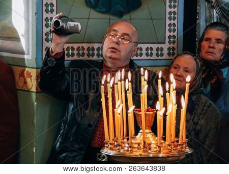 Voyutyn, Ukraine - 14 October 2008: Man Filmed On Video Camera Ceremony At Church