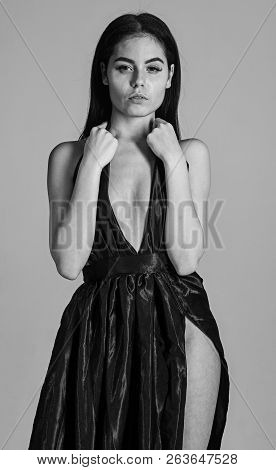 Sexy Decollete Concept. Woman In Elegant Black Evening Dress With Decollete, Grey Background. Attrac