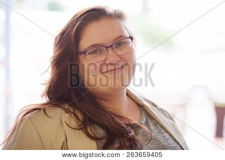 Close Up Portrait Of Beautiful Plus Size Young Adult Woman, With Brown Hair And A Beige Blazer, Whil
