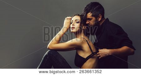 Young Couple Of Pretty Sexy Woman In Black Jeans And Bra Has Slim Body And Handsome Bearded Man With