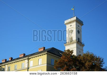 City Hall Tower With  National Flag Of Ukraine On Rynok Square In Lviv, Ukraine.