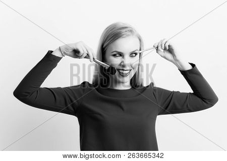 Girl Squinting Eyes On Silly Face With Makeup Brushes. Funny Woman Grinning With Crossed Eyes And Lo