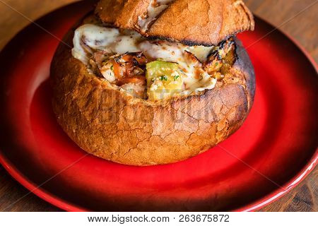 Meat Stew Served In Bread Bowl On Plate