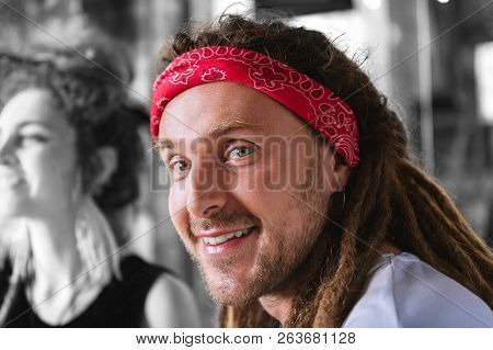 Handsome Bearded Man With Dreadlocks Wearing Red Head Band Smiling Broadly