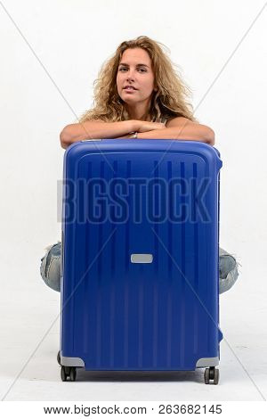 Beautiful Young Blonde Woman With Blue Plastic Suitcase On White Background