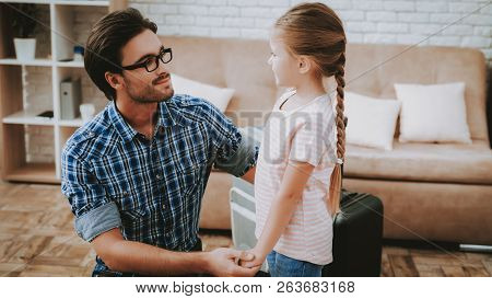 Brown Sofa In Apartment. People In Room. Smiling Family At Home. Father And Daughter. Family With Ch