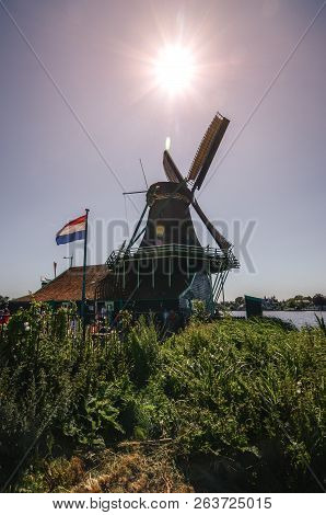 Detail Of A Large Dutch Mill With A Flag.