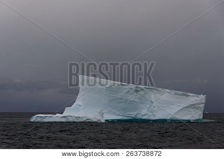 Antarctic Seascape With Tabular Iceberg At Sea