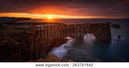 Panorama Of Beautiful Sunrise Over Dyrholaey Cliffs And Rocky Arch, Iceland