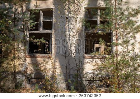 A Broken Window In An Old Abandoned Building. Broken Glass On The Window Site. Old Building.