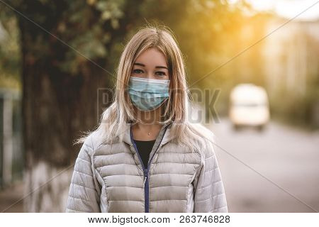 Woman Suffering From Sick And Wearing Face Mask. Woman In Protective Mask Feeling Bad On The Street 