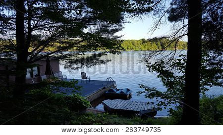 Cottage Dock And Boathouse On Beautiful Northern Lake In North America/canada.