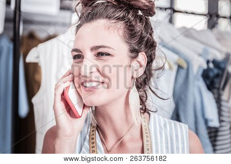 Dark-haired Businesswoman Holding Red Smartphone Calling Partner