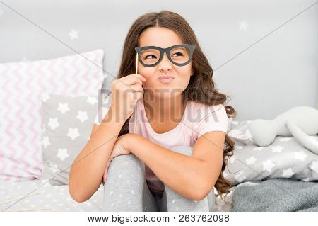 An Intellectual Look. Happy Small Girl. Small Girl Hold Fake Glasses On Face. Happy Childhood. Happy